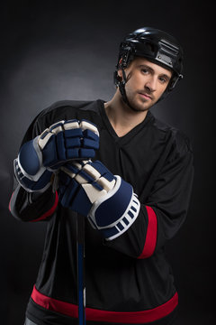 Attractive young hockey player posing on camera