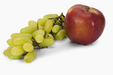 Close-up of a bunch of grapes with an apple