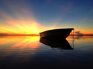 reflection on boat and sunrise
