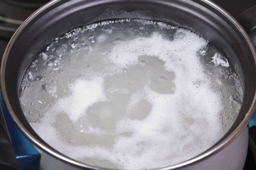 Close-up of rice boiling in a pan