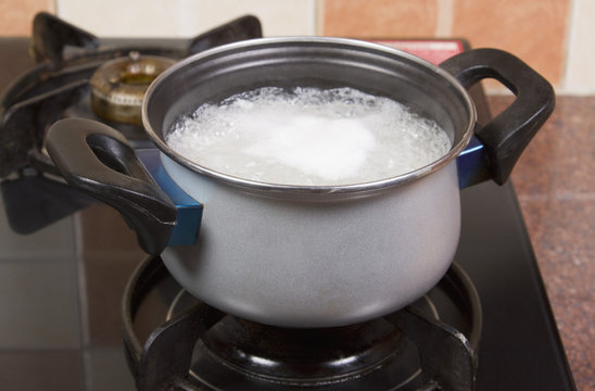 Rice boiling in a pan on a stove