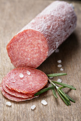 italian salami sausage slices with rosemary and sea salt