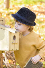 Child Looking Curious at one Birds House