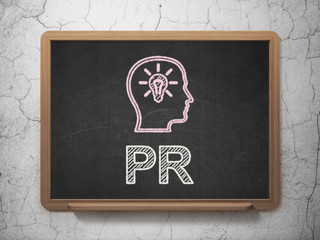 Advertising concept: Head With Lightbulb and PR on chalkboard