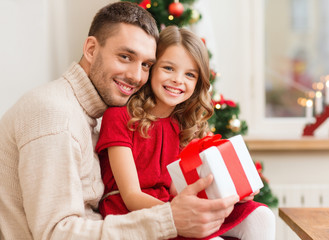 smiling father and daughter holding gift box