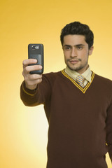 Businessman taking a picture from a mobile phone