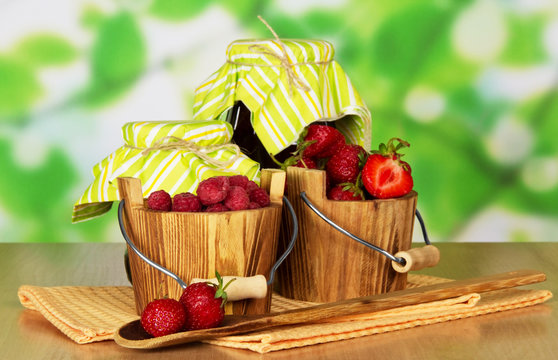 Two small wooden pail with berries