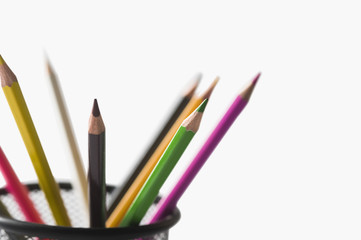 Close-up of colored pencils in a desk organizer