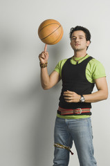Portrait of a man balancing a basketball on fingertip