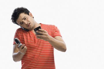 Man using multiple mobile phones