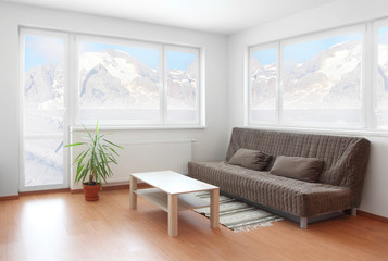 Living room with beautiful view to winter mountain.