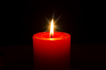 One red burning candle