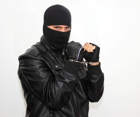 Masked criminal with handcuffs