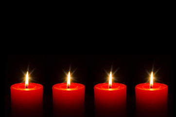 Four red burning candle for Advent