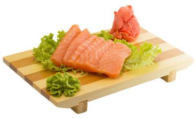 fresh raw salmon fish pieces on wooden plate isolated