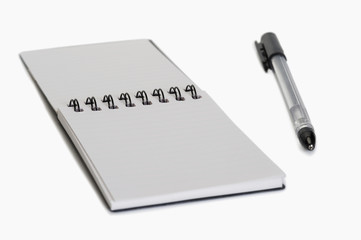 Close-up of a pen on a spiral notebook
