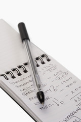 Close-up of a pen on a spiral notebook