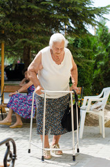 elderly woman standing with her walker