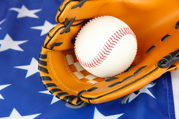 Baseball glove and ball on American flag background