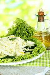 Delicious salad with eggs, cabbage and cucumbers on wooden