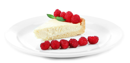 Slice of cheesecake with raspberry on plate, isolated on white