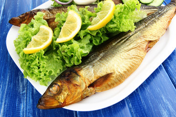 Smoked fish on plate close up