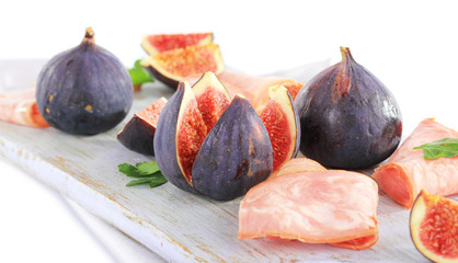 Tasty figs with ham, isolated on white