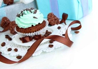 Tasty cupcake with gifts close up