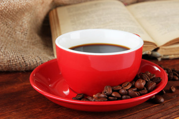 Cup of coffee with coffee beans and book