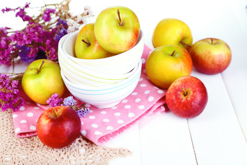 Naklejka na ściany i meble Juicy apples on plate on white wooden table