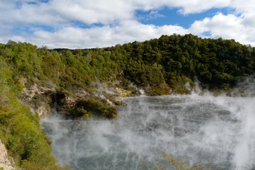 Fototapeta premium Steaming geo-thermal crater and lake in Waimangu Thermal Park