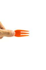 hand with orange fork isolated on white