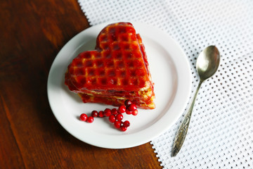 Sweet Belgium waffles with jam, on wooden table background