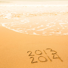 2013 - 2014, written in sand on beach texture