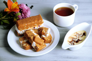 Sherbet with nuts on plate on wooden table close-up