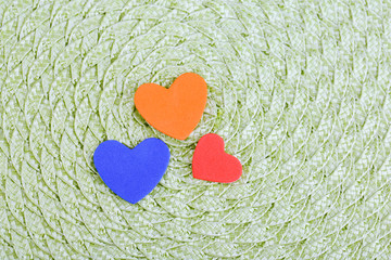 Hearts made of felt on green background