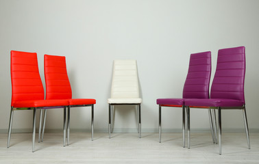 Fototapeta premium Modern color chairs on wall background