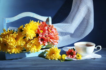 Beautiful flowers in basket, on dark wooden background