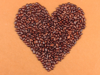 Heart of sunflower grains in chocolate, on brown background