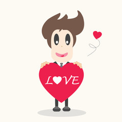 Businessman holding a red heart