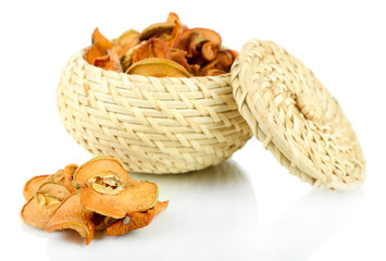 Dried apples in wicker basket, isolated on white