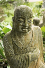 Fototapeta na wymiar Ruined statue Ksitigarbha Bodhisattva