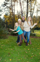 Fototapeta premium Family Dancing during a nice Autumn Day in the park