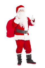 merry Christmas Santa Claus holding gift bag with thumb up