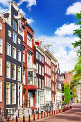 Obraz premium Amsterdam and typical houses with clear summer sky.Netherlands