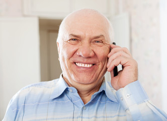 joyful  senior man speaking by mobile