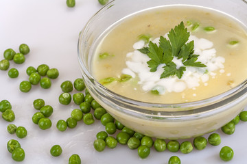 Obraz na płótnie Canvas homemade pea soup with cream and parsley