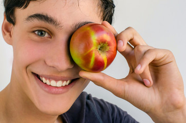 Beautiful man smiling and holding a red apple