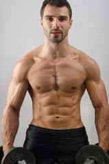 Fototapeta premium Bodybuilder training with heavy dumbbells