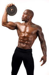 Black bodybuilder training with round discs